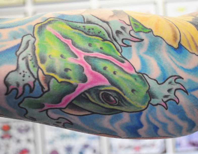 tattoo of a green and pink frog 